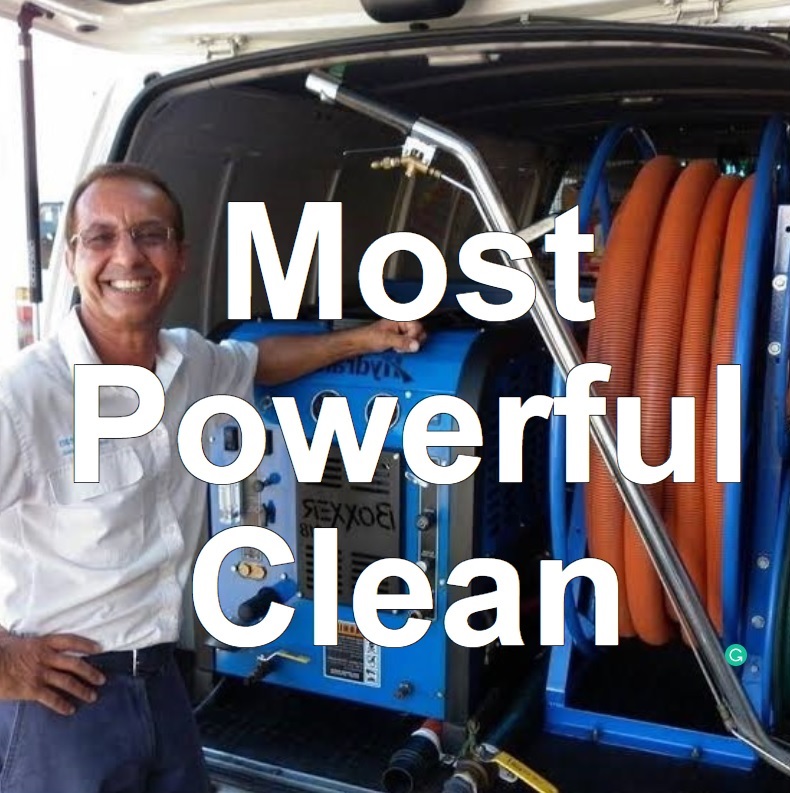 A friendly guy smiling in front of a truckmount cleaning machine with the words Most Powerful Clean