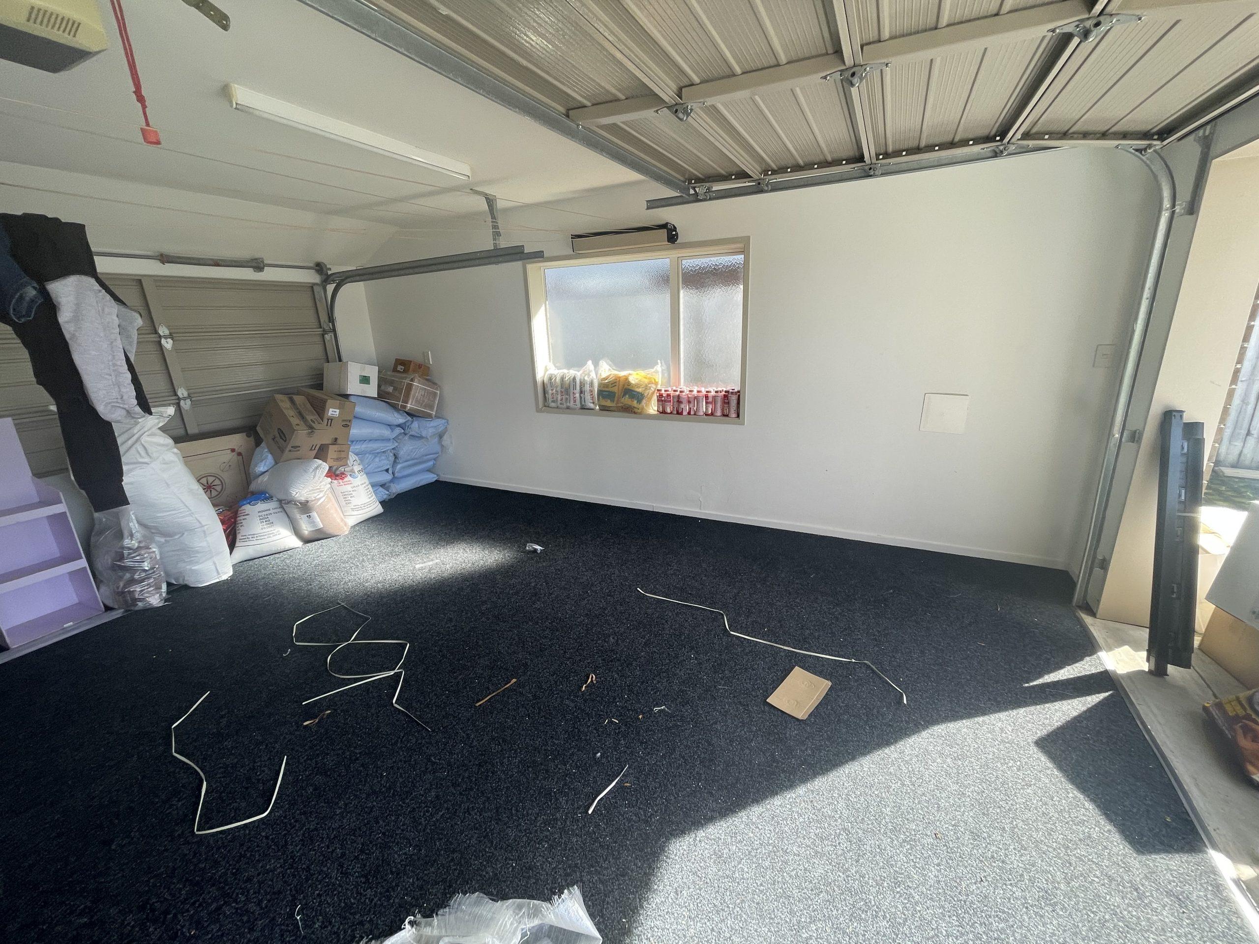 Initial garage assessment after the documented washing-machine leak