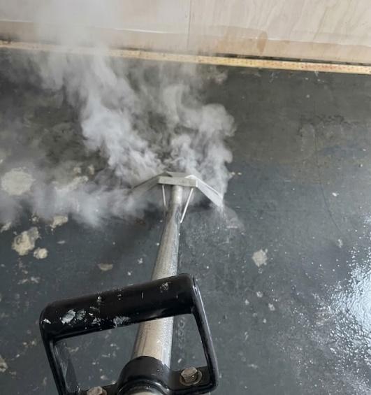 Hot-water extraction during a structural flush of an exposed concrete subfloor
