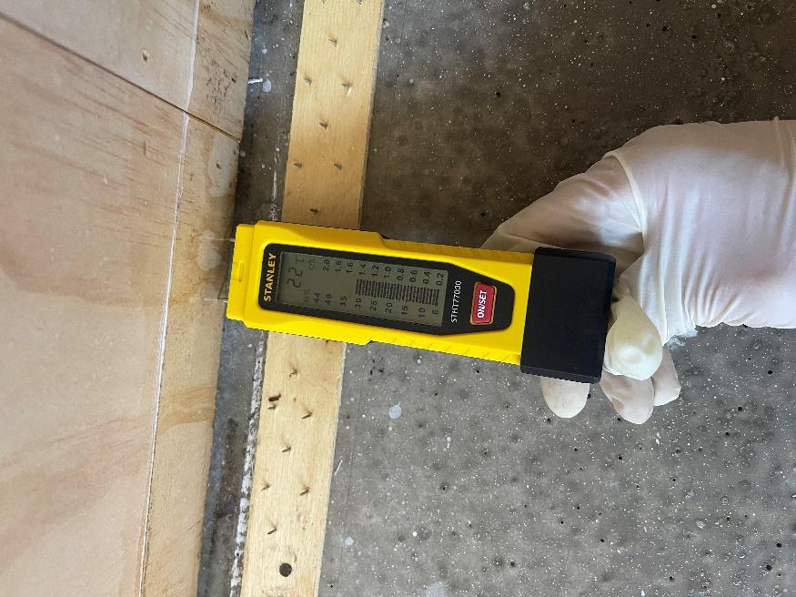 Initial wall moisture reading during structural drying assessment